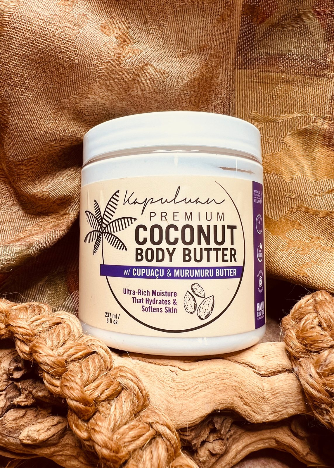Coconut body butter jar styled on textured fabric